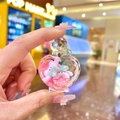 Close-up of heart-shaped acrylic liquid keychain with pink bunny and sequins details - Heart Perfume Bottle / Luminous Donut Heart Perfume Bottle