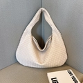 Elegant off-white woven leather hobo bag featuring a sophisticated minimalist hand-held design - White