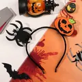 Halloween headband featuring a fuzzy black spider and orange pumpkin face decoration - Pumpkin And Spider Headband