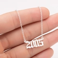 Detail of 2005 birth year pendant in gothic font on a delicate O-chain necklace - 2005 / Steel