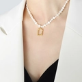 Baroque pearl necklace with textured gold rectangular pendant shown on a model - 38+8cm / Gold