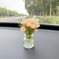Pink and white artificial flower vase with Good Luck sticker on car dashboard - Champagne Jasmine