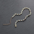 Golden evil eye anklet with blue and white beads on dark stone background - Gold Cyan Anklet
