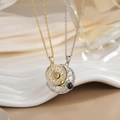 Detailed view of interlocking gold sun and silver moon necklaces on ceramic display - Gold Silver Puzzle Sun Moon Projection XL0287G