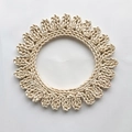 Handwoven round corn husk placemat with decorative scalloped edges in light beige color - Hollow Style