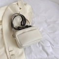 Minimalist beige textured crossbody bag with a stylish striped canvas wide strap - White