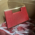 Detail of red sequined clutch bag with gold handle stored in distribution packaging - Long Chain Included / Red