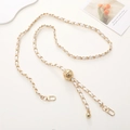 Detail of gold metal phone chain with white leather weave and adjustable gold ball slider - White