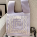 Purple knit tote bag with yellow zigzag patterns on a cozy textured sofa background - Dizziness Palindrome Purple