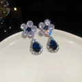 Detailed shot of sparkling zircon flower earrings with blue pear-shaped drop pendants - Blue Pear Shaped Flower Drop Earrings with Silver Earring Post (16#)