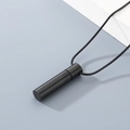 Matte black cylindrical perfume pendant necklace with black cord on white podium - Black (KN299104-ZLA) / Black