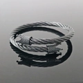 Detail of twisted cable cuff bracelet in gunmetal grey featuring ornate crown end caps - Crown Head Bangle Black