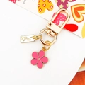 Pink floral keychain with handmade tag and gold finish for women's bags and keys - Rose Red
