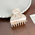 Beige and pink mottled acetate hair claw clip with vintage glossy finish on wood table - White Orange Semi-Circle Claw