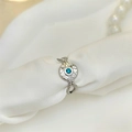 Vintage stainless steel starburst ring with blue gemstone on white silk background - Adjustable Open / Silver with Blue Zirconia