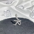 Detail of silver snake ring with pavé diamonds and green gemstone eyes on stone - Style 4 Adjustable Ring