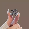 Butterfly hair claw with grey pearls and metallic finish shown in hand - Butterfly Pearl Mini Claw (Per Piece)