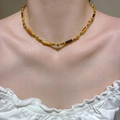 Macro detail of layered tiger eye beaded necklace with golden metallic accents on skin - Gold Bead Dark Brown Cylinder Necklace Style (9655)