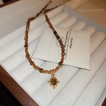 Detail of vintage beaded necklace with tiger eye stone sun pendant on jewelry box - 38# Necklace-Coffee-Oval Irregular