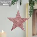 Pink star-shaped Christmas ornament with rose gold glitter on a green pine tree branch - Five-Pointed Star Style A
