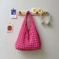 Pink pleated cloud puff shoulder bag with floral fabric texture hanging on a wooden hook - Rose Red