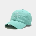 Close-up of mint green cotton baseball cap with white Keep The Faith embroidery detail - Adjustable / Teal