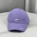 Macro view of purple baseball cap with distressed torn details and white 3D embroidery - Purple