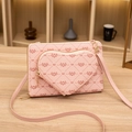 Pink crossbody bag with heart pocket, featuring diamond quilt pattern and gold zipper - Pink