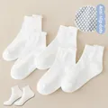 Close-up of five pairs of white mesh kids socks featuring anti-slip grip dots on the sole - Dotted Flat Pull-Tab Socks / 5 Pairs/Pack / White / 8mo-2yr XS (Foot 9-12cm)