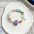 Handmade ceramic beaded bracelet featuring purple shell charms and colorful star beads - 1048-01 Orange Bay