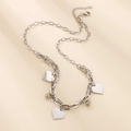 Detailed view of silver layered heart pendants and mixed chain texture on neutral background - Steel Color Necklace (KN203246-Z)