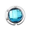 Foldable silver bag hook with blue faceted crystal gemstone on white background - Light Blue