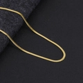 Close-up of a minimalist golden flat snake chain necklace with smooth metallic luster - Gold Blade Chain 3mm Wide 45+5cm