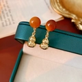 Macro shot of gold gourd drop earrings with orange beads on dark green jewelry box - Gold-Coffee (S925 Silver Pin)