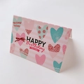 Close-up of birthday card with pink heart patterns and Happy Birthday typography - Happy Birthday Heart