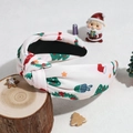 Detail shot of a white knotted headband with colorful Christmas tree and gift patterns - Beige Christmas Tree