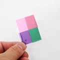Close-up of four colorful miniature dollhouse books in a clear pack for BJD scenes - Purple