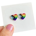 Detail of glitter heart stud earrings featuring Progress Pride Flag colors on display card - Progress Pride Style
