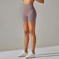 Detail shot of dusty pink high-waisted yoga shorts showing wide waistband and fit - Taupe