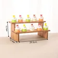 Two-tier wooden display stand for jewelry and figurines with natural wood texture - 2-Tier Ladder Stand / Walnut Color