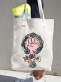 Off-white canvas tote bag featuring floral girl power illustration and shoulder straps - Girl Power Illustration