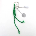 Detailed close-up of a shuttlecock and racket keychain with green braided nylon cord - Green Rope + Badminton