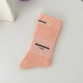 Peach pink ribbed mid-calf cotton socks with minimalist branding label in flat lay - Light Pink