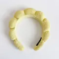 Macro shot of fluffy yellow sponge headband with soft terry cloth texture and black lining - Single Headband / Yellow