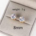 Macro shot of 8mm classic four-claw zircon earrings in a gray jewelry box, weight 2g - 8mm / Gold