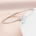 Elegant silver interlocking heart bangle with polished beads on a minimalist open band - Steel
