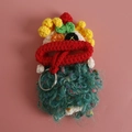 Handmade crochet sausage mouth key case in vibrant purple and green yarn colors - Gold Boy Style