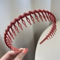 Brick red wavy headband with fine teeth for non-slip grip and matte finish styling - Red