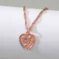 Macro view of rose gold necklace featuring an embossed rose flower on heart pendant - Heart Rose Relief Necklace (Rose Gold)