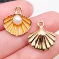 Enamel shell charms with pearls held by hand for DIY jewelry and keychains - Orange Shell With Pearl